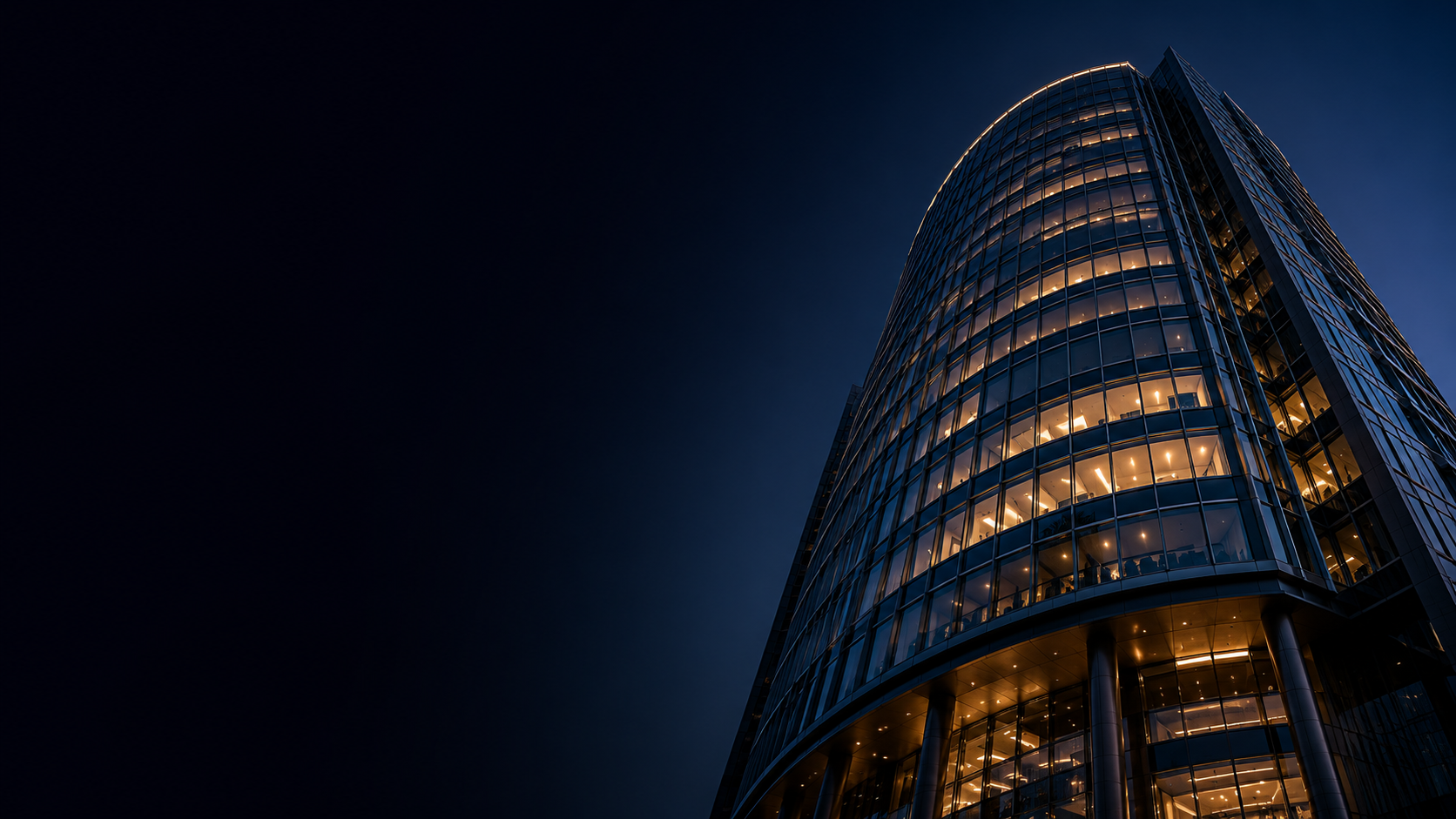 Kerogen CX — curved glass headquarters at dusk