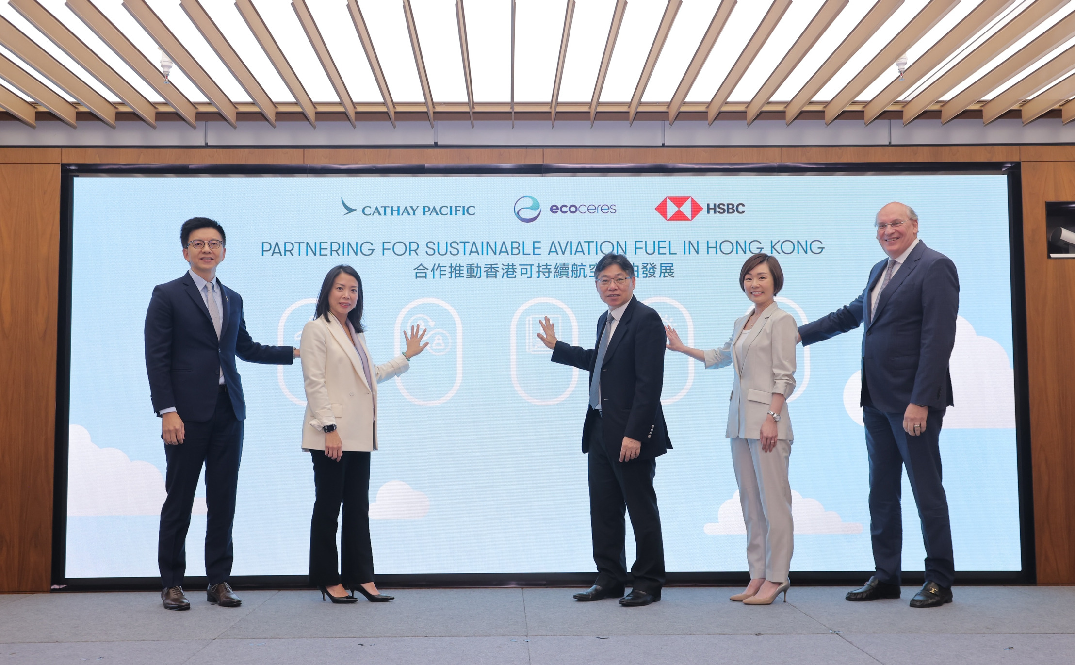 Five executives on stage at the launch ceremony in front of a screen reading Partnering for Sustainable Aviation Fuel in Hong Kong, with the Cathay Pacific, EcoCeres and HSBC logos