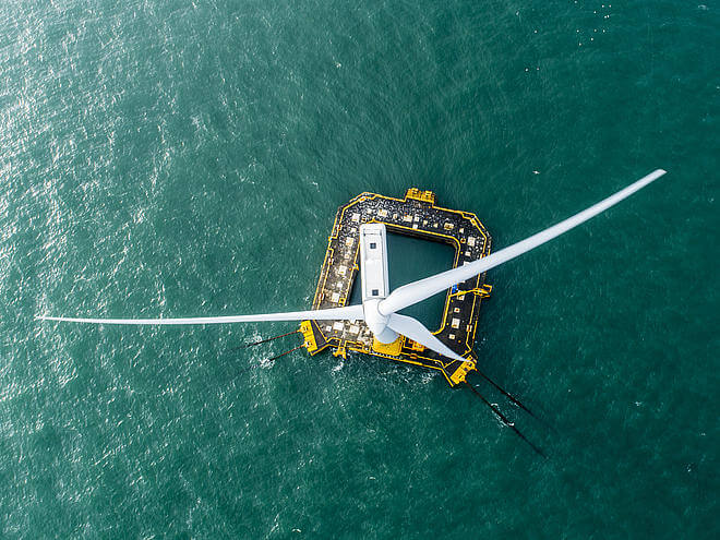 Overhead view of the Floatgen turbine and its yellow ring-shaped floating foundation on open water